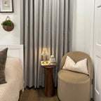 Pinch pleat Natural Beige Orion Linen Look Blackout Curtains styled in a cozy bedroom corner