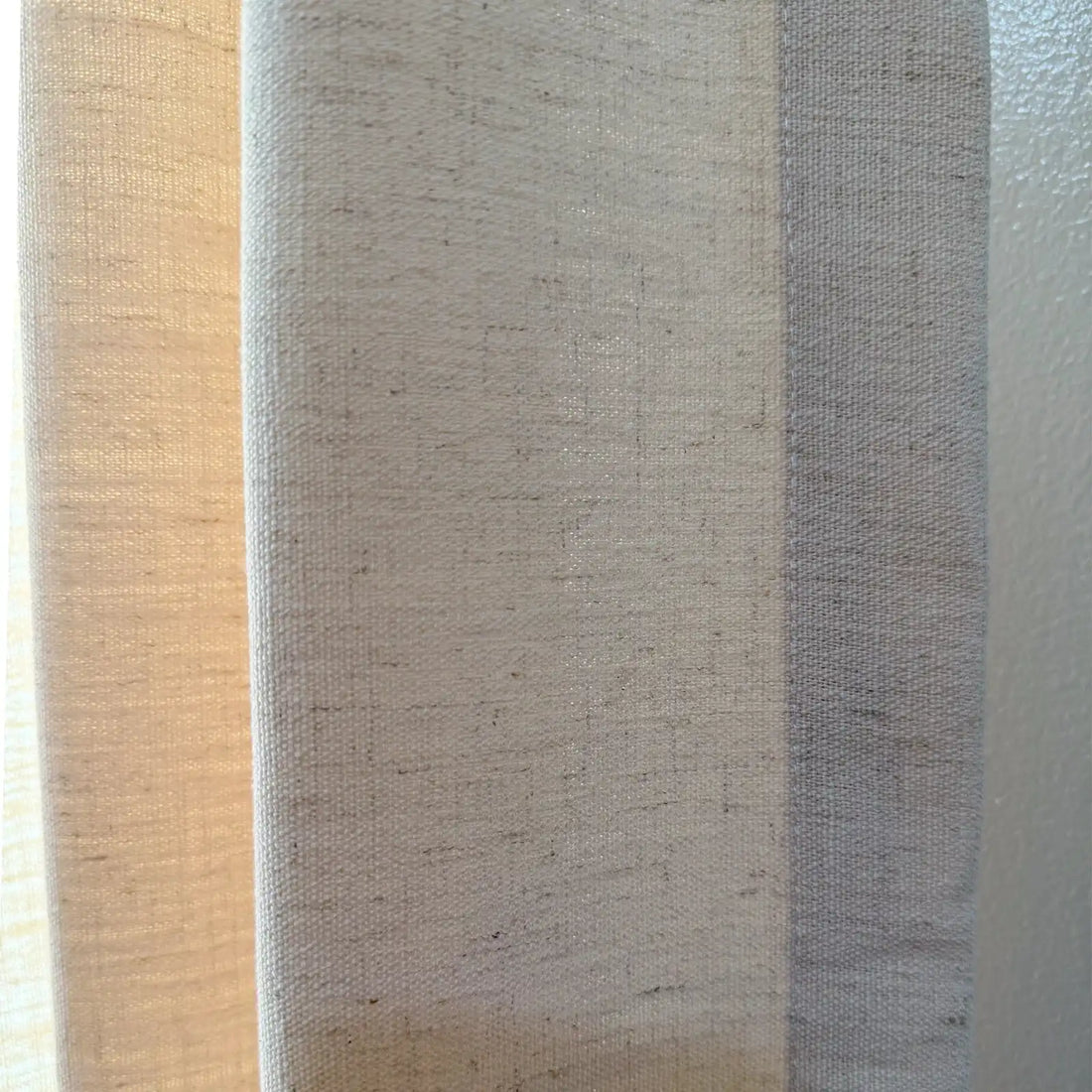 A close-up of the fabric texture of Jasper Dotted Linen Blend Curtains in Vanilla Cream, showcasing the slub weave.