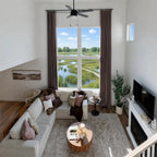 Coffee John Linen Texture Cotton Curtains styled in a cozy warm toned living room with a tan leather sofa