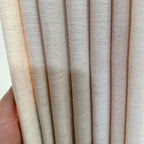 Close up of textured dots on Jasper Dotted Linen Blend Curtains in Vanilla Cream fabric folds