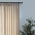 Pinch pleat header style of Jasper Dotted Linen Blend Curtains in Vanilla Cream on black rod