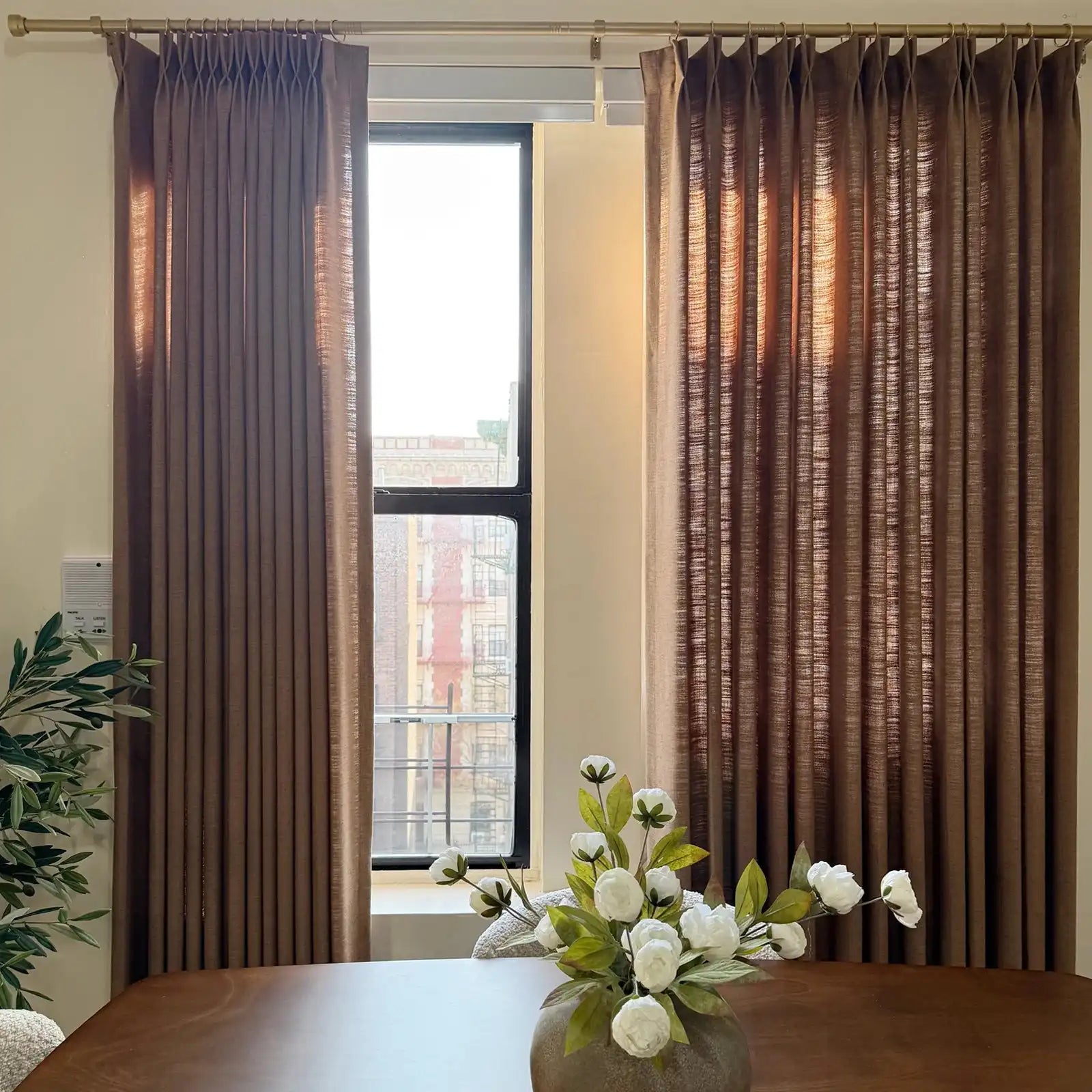 Pinch pleat Rusty Brown Jasper Dotted Linen Blend Curtains on dining room window with gold rod
