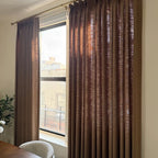 Light filtering Rusty Brown Jasper Dotted Linen Blend Curtains catching natural sunlight by the window