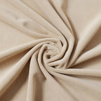 Close-up showing the soft texture and luxurious sheen of the beige Adrian cashmere blackout curtain fabric swirled into a spiral.