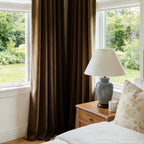 A close-up focusing on the neatly tailored bottom hem of the curtains, hanging perfectly straight over a polished white marble floor with a dramatic sliver of light peeking from underneath.