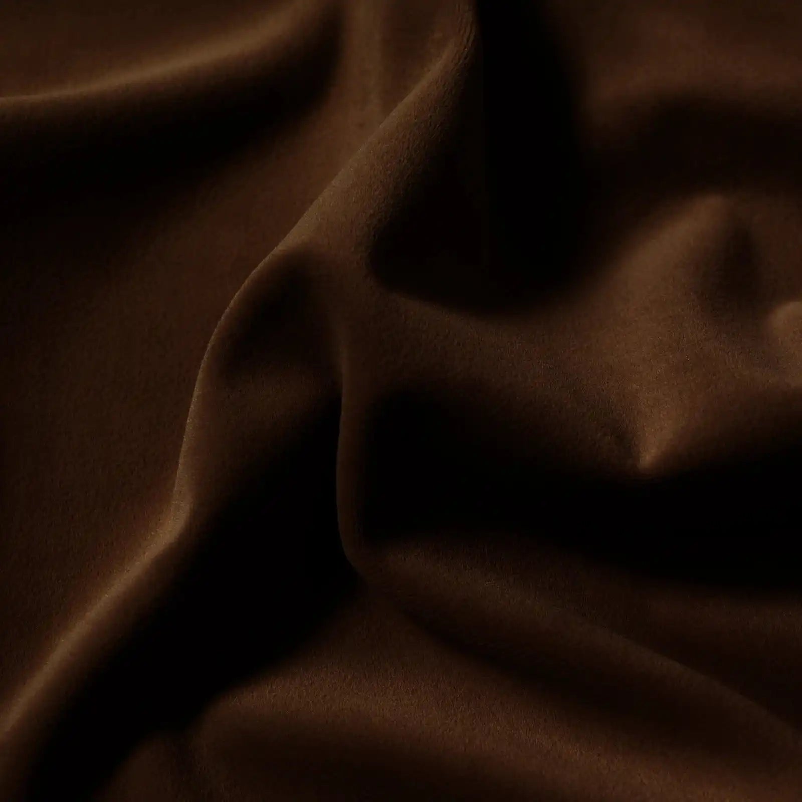 A beautiful close-up shot showcasing the sleek, smooth surface and soft vertical drapes of the rich, deep brown fabric.