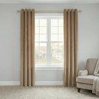 A wide-angle, full-length shot of a white-framed window covered by a pair of fully extended Adrian Cashmere Blackout Curtains in Camel Yellow. The curtains are hung from a simple brass-toned rod.