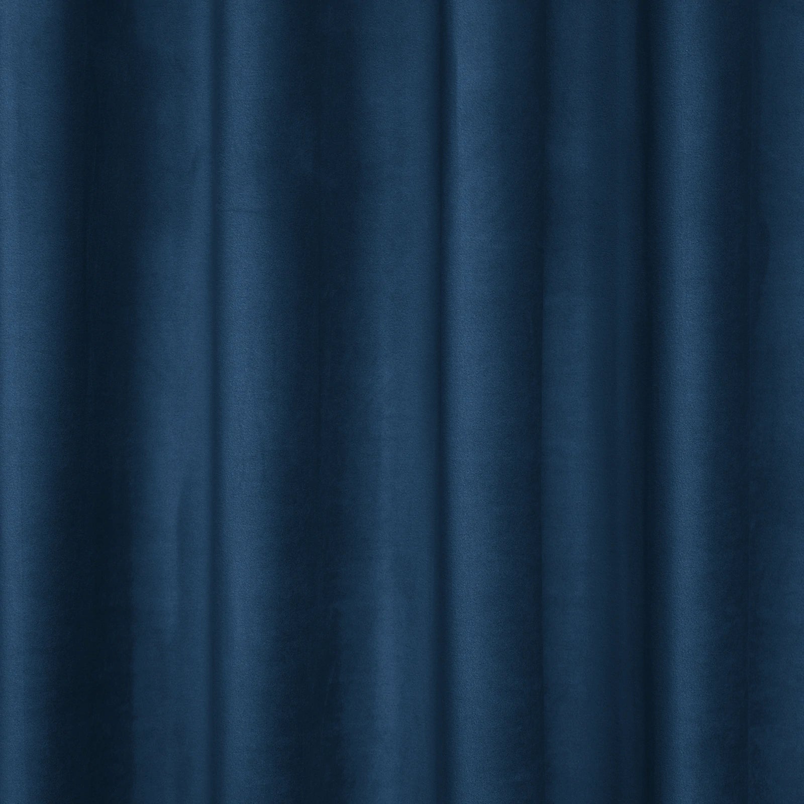 A tight, vertical shot showcasing the uniform, crisp pleats and structured vertical folds of the deep sea blue curtain fabric as it hangs.
