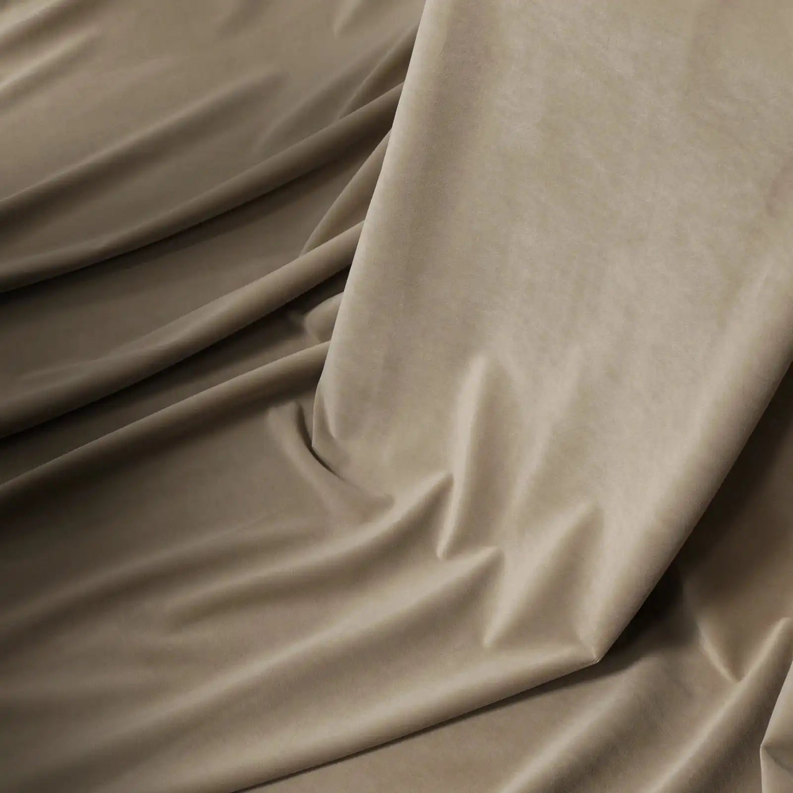 An elegant shot of the Adrian Cashmere Blackout Curtains fabric in Light Gray-Brown, gracefully rippling with soft, rich folds that highlight its smooth texture.