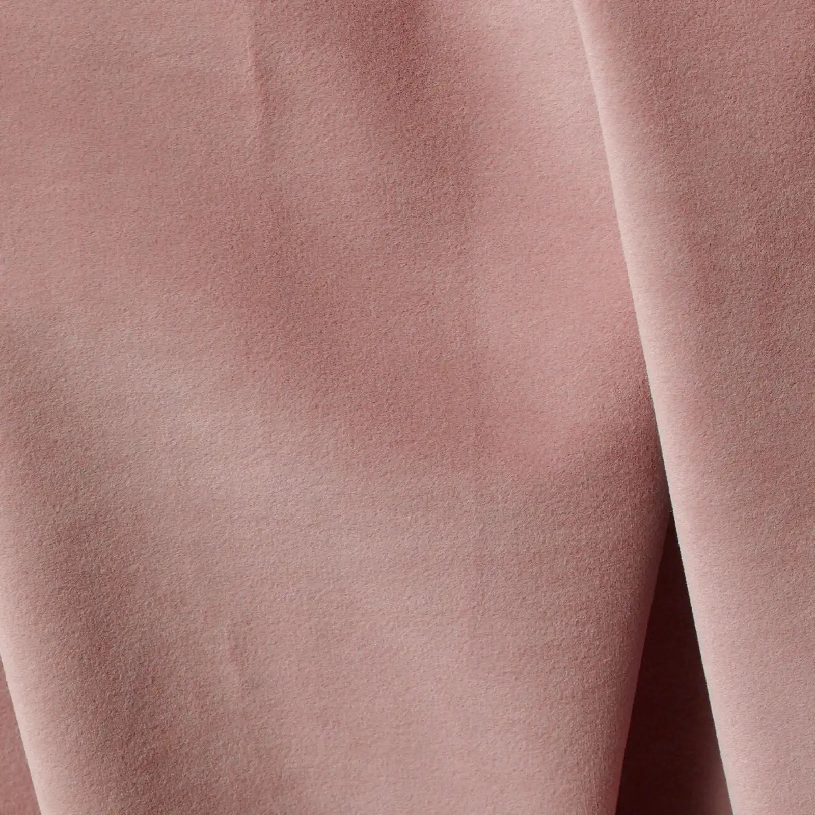 An extreme macro photograph highlighting the fine, velvet-like surface texture and luxurious weave of the pink curtain fabric.