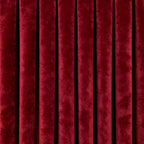 A tight, direct shot showing the crisp, uniform vertical pleats and deep, luxurious coloration of the hanging curtain panel.