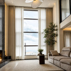 Beige Alex 100% blackout curtains with white sheers on tall modern living room windows