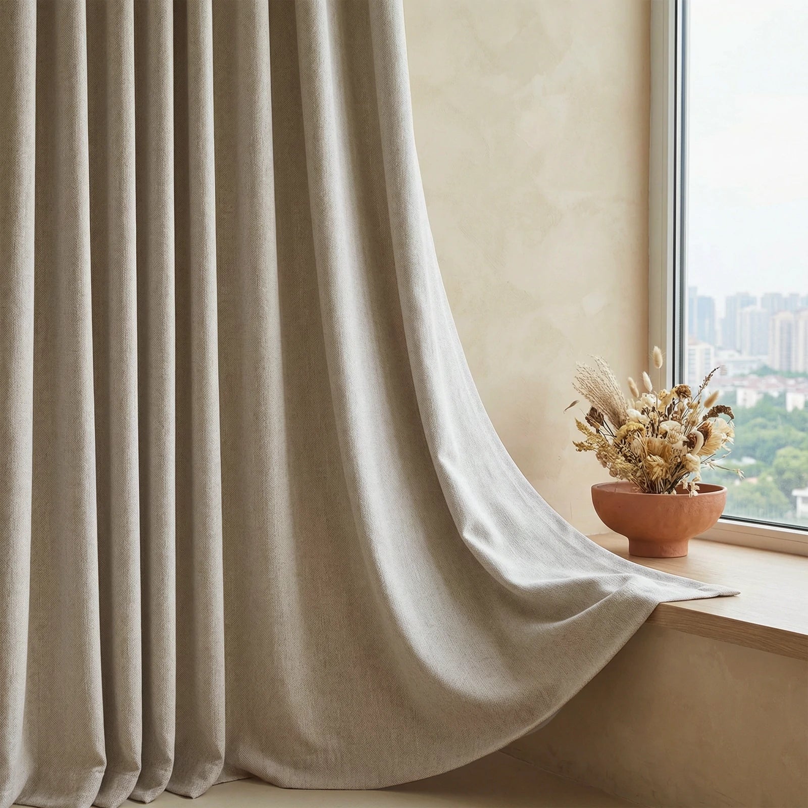 Extra-long beige Alex blackout curtain panel beside a sunlit window and dried flowers