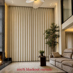 Fully closed beige Alex blackout curtains covering floor-to-ceiling living room windows