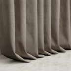 Coffee Alex blackout curtain hems pooling neatly on a light marble floor