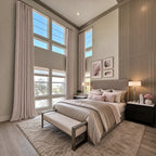 Light pink Alex extra-long blackout curtains on tall windows in an elegant bedroom
