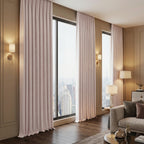 Light pink Alex blackout curtains framing high-rise windows in a modern living room