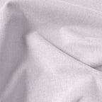 Macro view of light pink Alex blackout curtain fabric and fine woven texture
