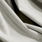 Close-up of off-white Alex blackout fabric showing woven face and dark backing