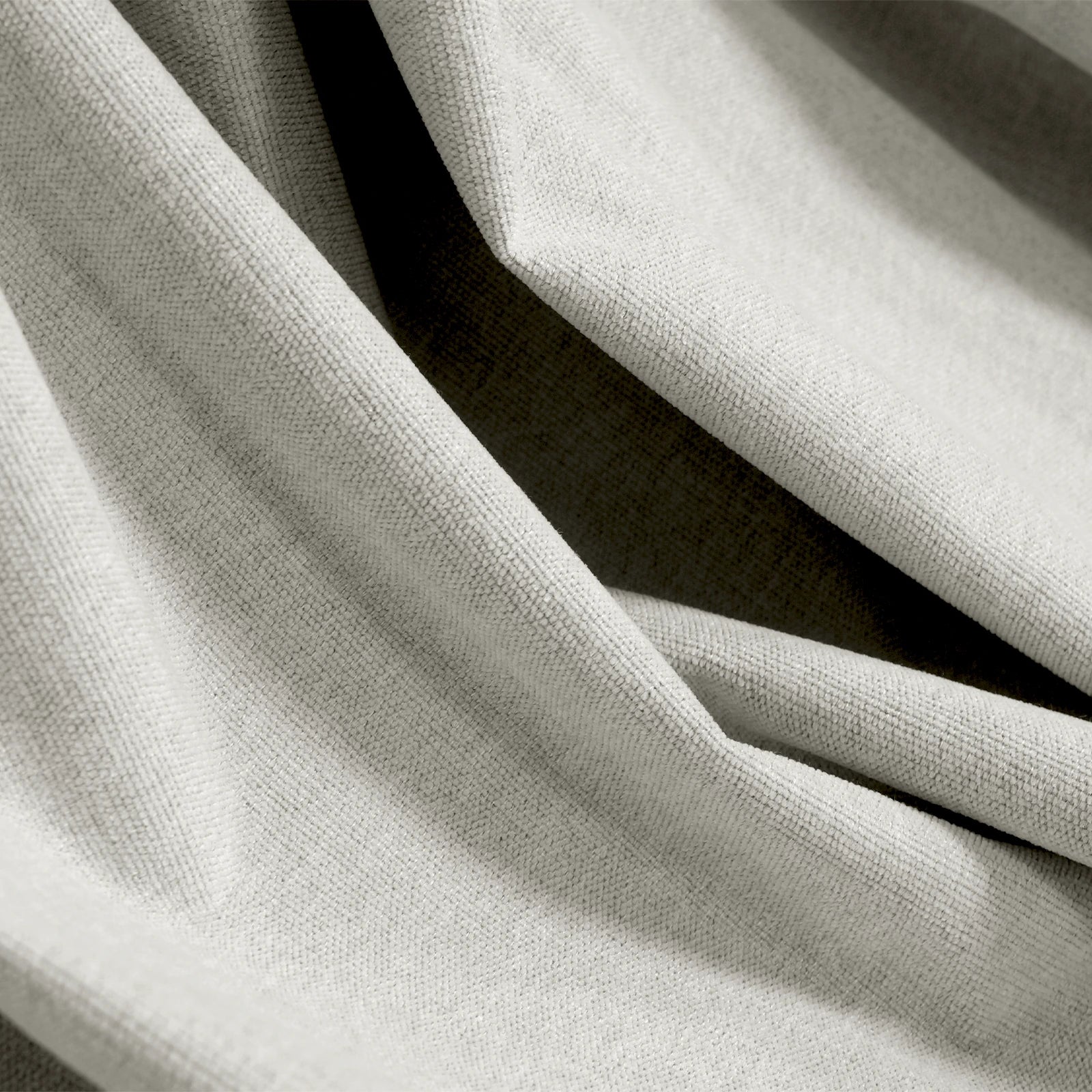 Close-up of off-white Alex blackout fabric showing woven face and dark backing
