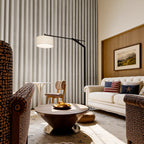 Off-white Alex blackout curtains styled behind a modern sofa and statement floor lamp