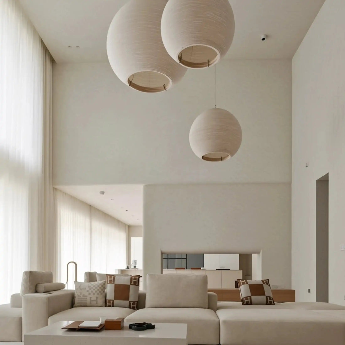 Ayla Weave Extra Long Sheer Curtains hang naturally in the living room, with several huge chandeliers above.