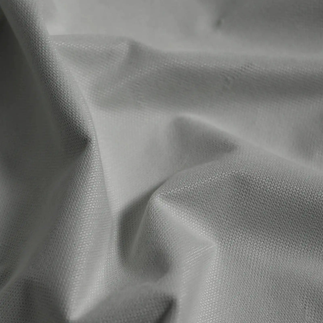 Macro detail of cool gray Gavin curtain fabric arranged in soft folds