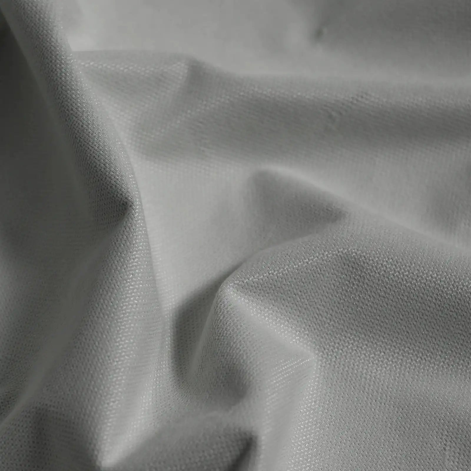 Macro detail of cool gray Gavin curtain fabric arranged in soft folds