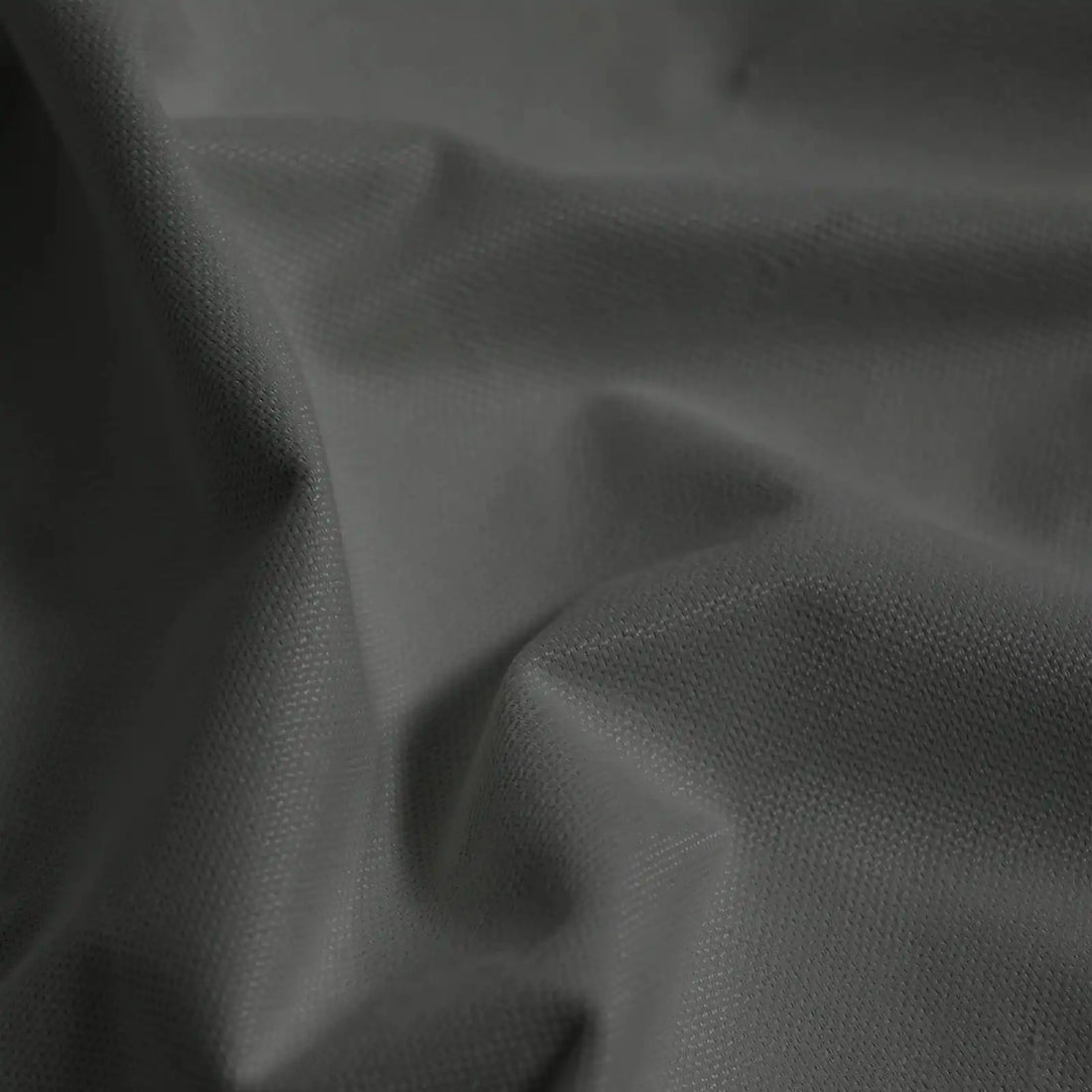Macro detail of dark gray Gavin curtain fabric arranged in soft folds