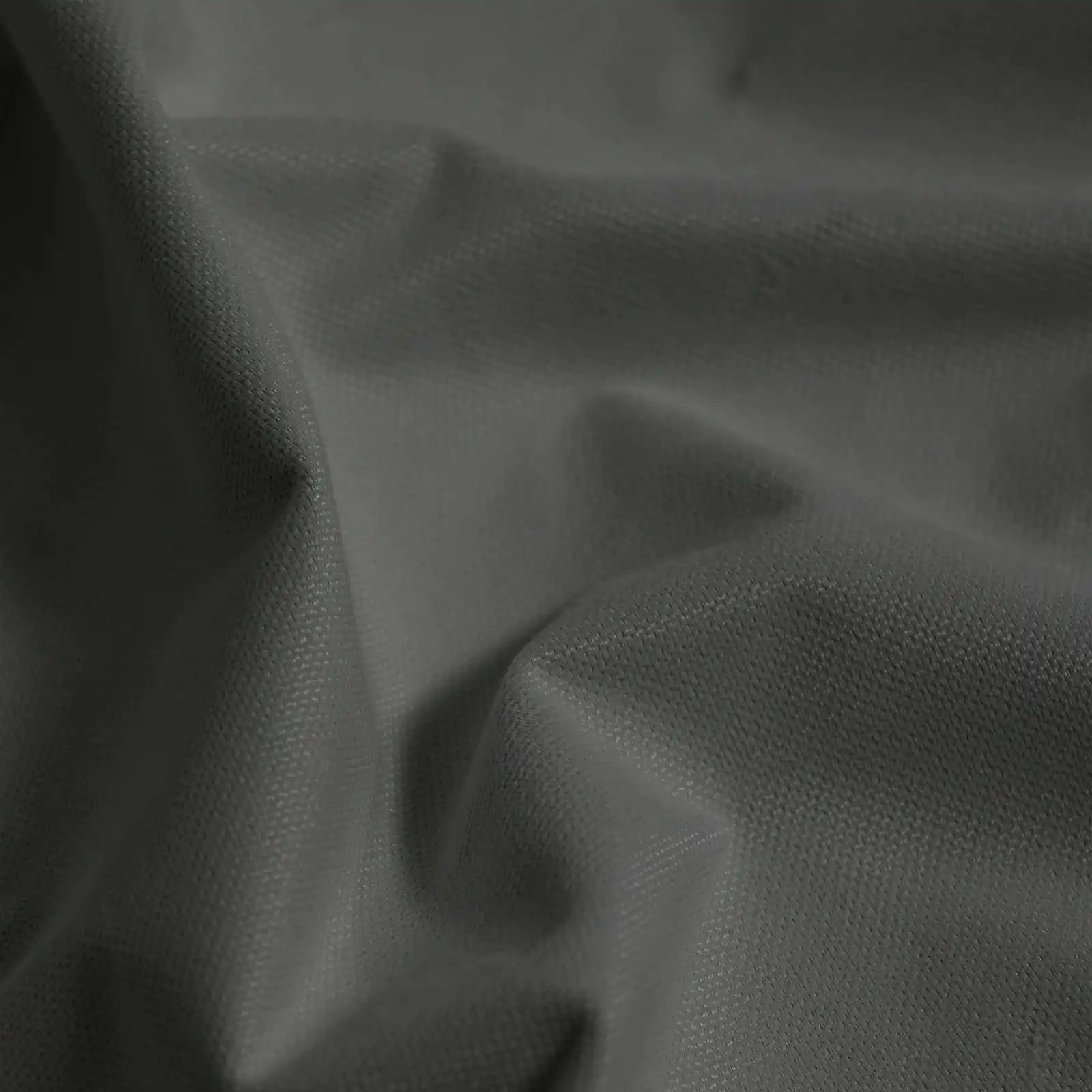 Macro detail of dark gray Gavin curtain fabric arranged in soft folds