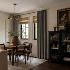 Dark gray Gavin curtains styled across three windows in a modern bedroom