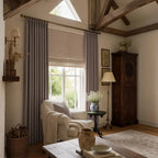 Purplish gray Gavin curtains styled across three windows in a modern bedroom
