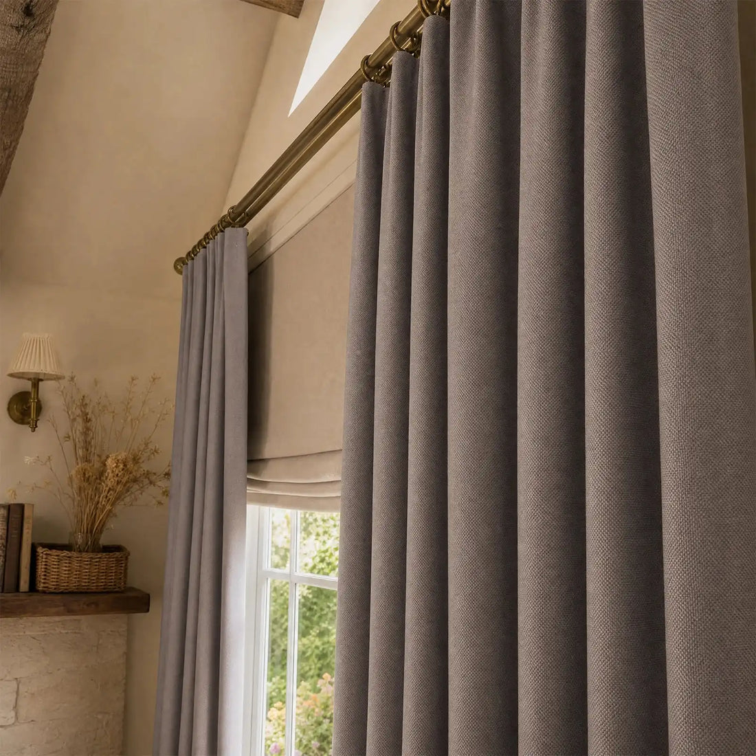 Close view of purplish gray Gavin curtain folds beside a sunlit window and plant