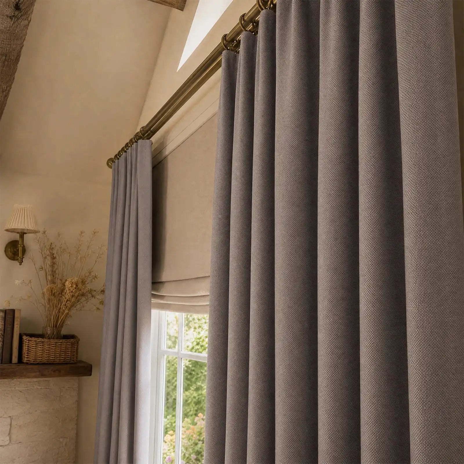 Close view of purplish gray Gavin curtain folds beside a sunlit window and plant