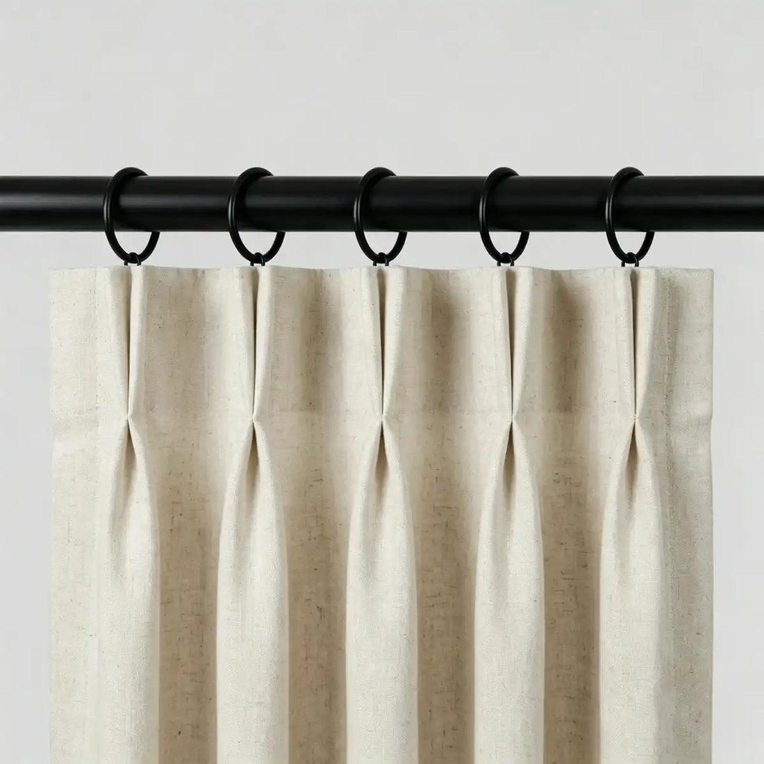 Set of two black steel curtain rings with loops, displayed on white surface, suitable for curtain hanging accessories in home decor