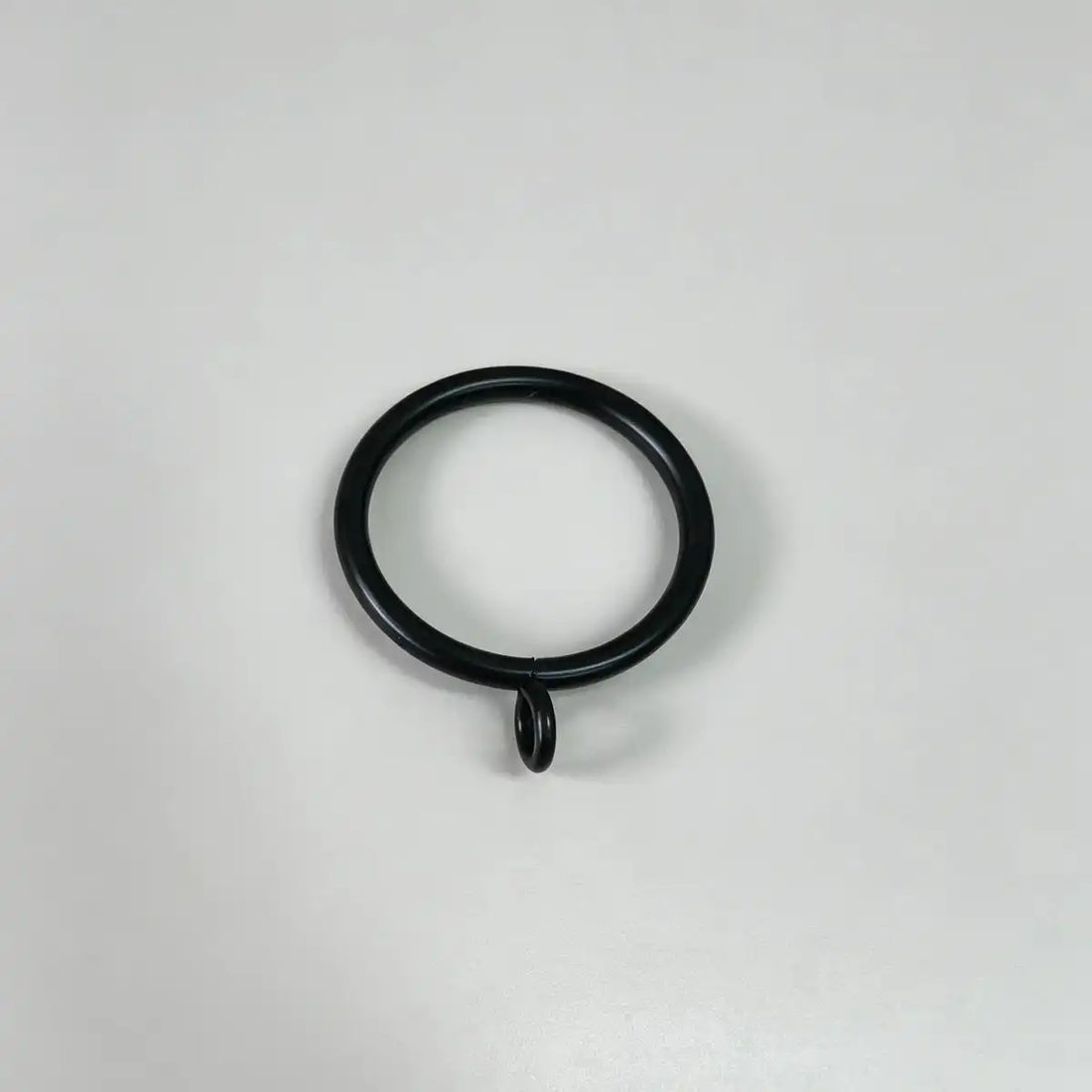Black steel curtain ring with small attached loop for hanging curtains, used in home decor, set of 20pcs, on plain white background