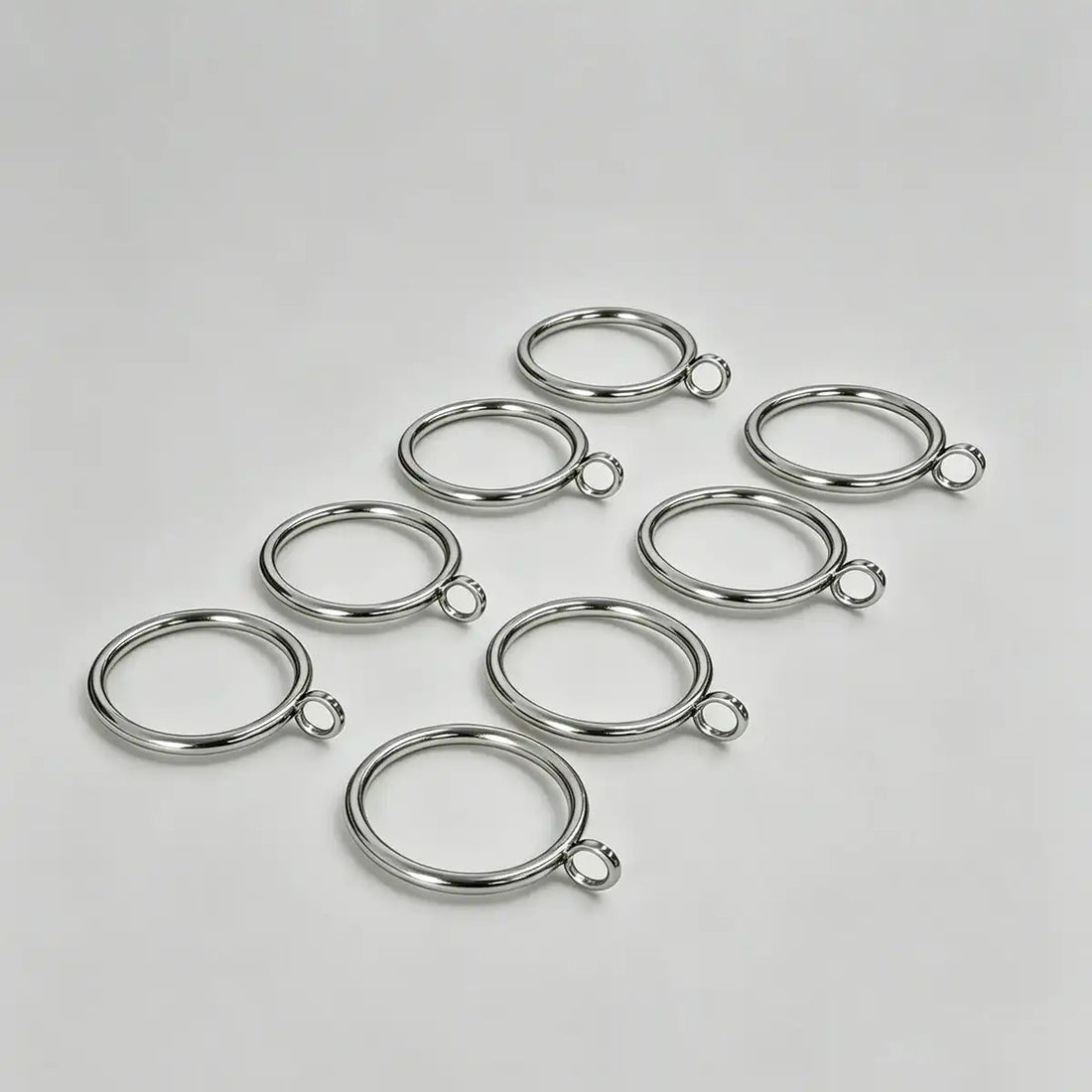Set of 20 stainless steel curtain rings with small loops for hanging curtains, ideal for home decor and window treatments