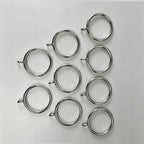 Close-up of stainless steel curtain rings with small loops, measuring 1 1/2 inches in diameter, used for hanging curtains