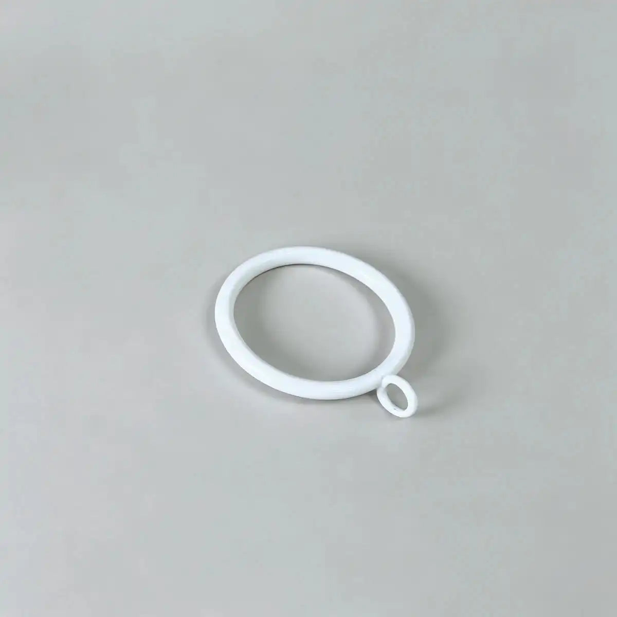 White oval curtain ring with small loop, used for hanging curtains, shown against a neutral background
