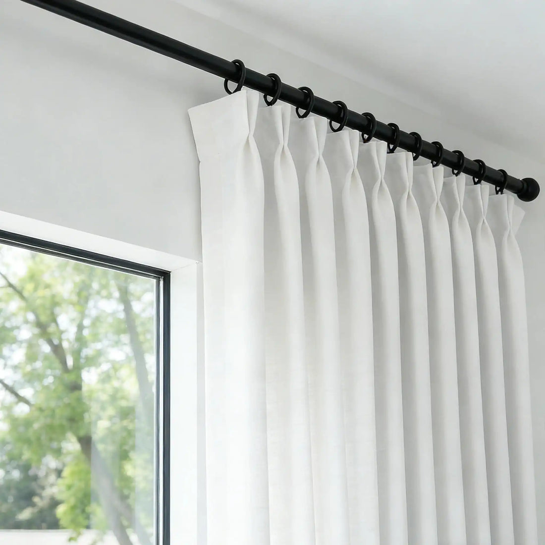 Detailed view of black rod rings holding the precise pinch pleat header of White John Linen Texture Cotton Curtains