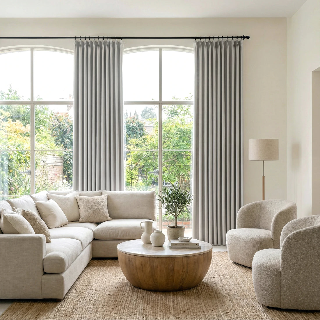 Light Gray John Linen Texture Cotton Curtains dressing large arched windows in a sunlit neutral living room