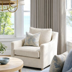 Cream fabric accent chair positioned beside the soft drape structure of Pearl Gray John Linen Texture Cotton Curtains