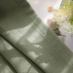 Close up organic slub weave detail of Grass Green John Linen Texture Cotton Curtains in natural sunlight