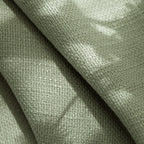 Detailed textile background showing the organic fibers and premium tailoring of Grass Green John Linen Texture Cotton Curtains