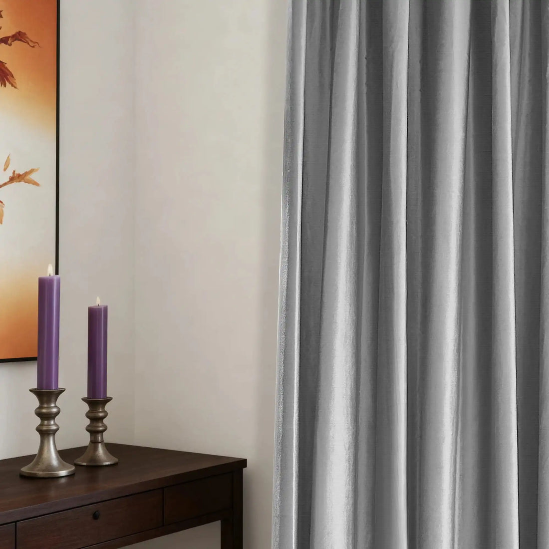 Gray velvet curtains with textured fabric hanging on a wooden rod, in a minimalist room with white walls and a large window.