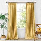 Modern living room with yellow velvet curtains, large window, ceiling fan, beige walls, and comfortable seating, home interior
