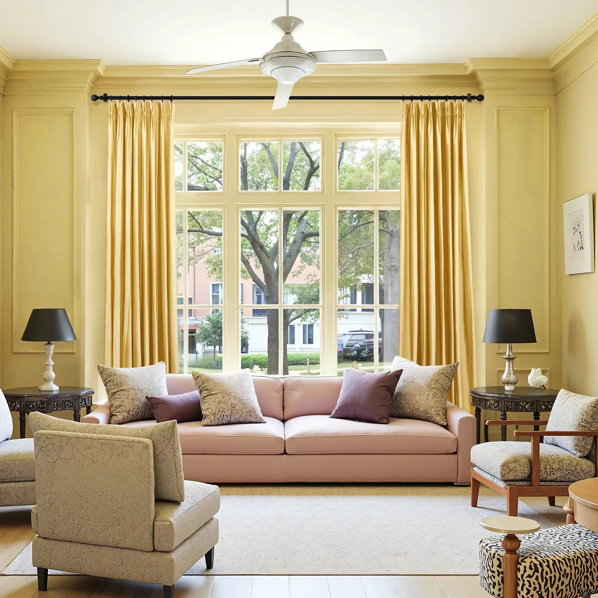 Living room with large window, yellow velvet curtains, ceiling fan, beige walls, and cozy seating area, home interior design