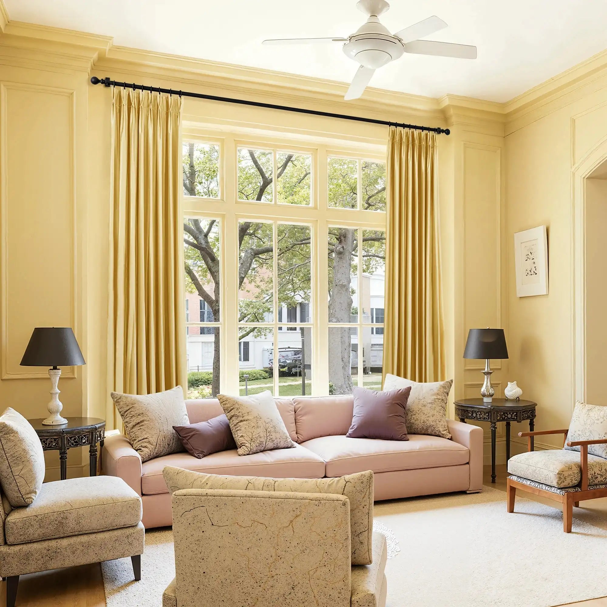 Elegant yellow velvet curtains hanging in front of large window with trees outside, bright natural light, stylish home decor