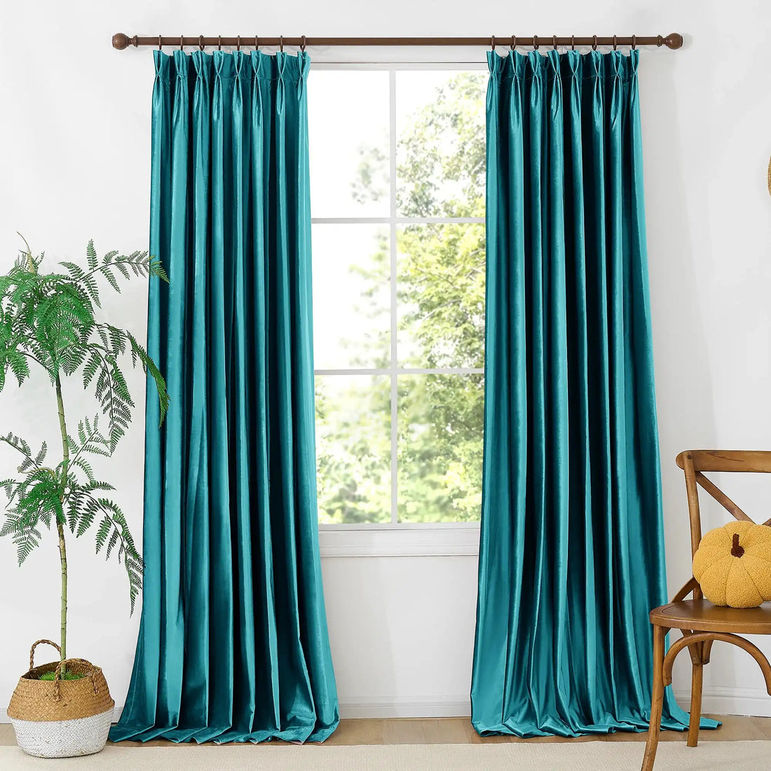 Close-up of teal velvet fabric with a soft, plush surface, showcasing the rich color and smooth texture of the curtains.