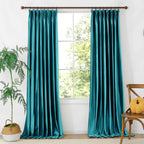 Close-up of teal velvet fabric with a soft, plush surface, showcasing the rich color and smooth texture of the curtains.